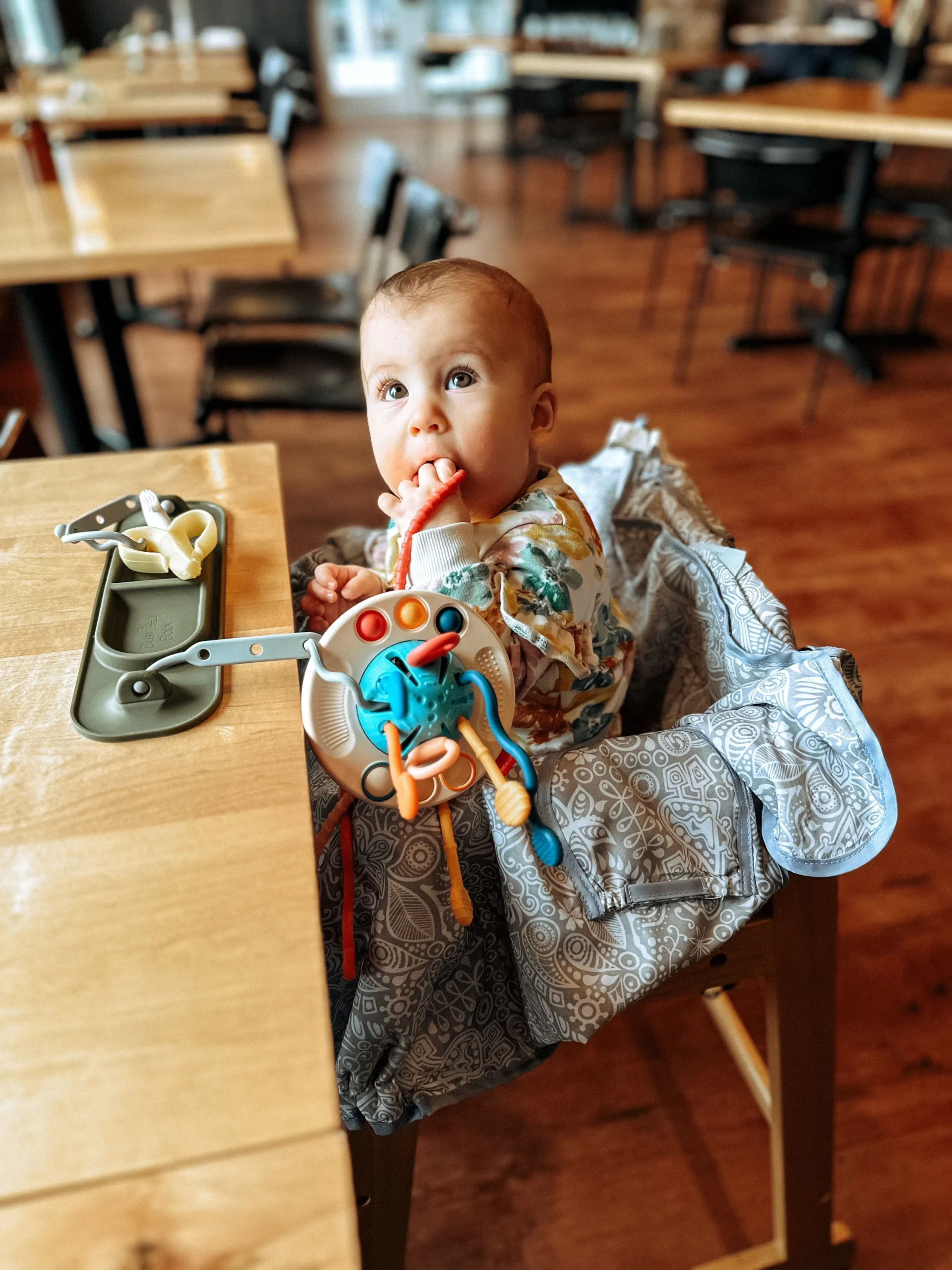  This   high chair cover   is everything!! And it doubles as a shopping cart cover, too. Wins ALLLLL around.  Do you spy the   suction busy mat?   I talk about it below, but it’s AMAZING too! 