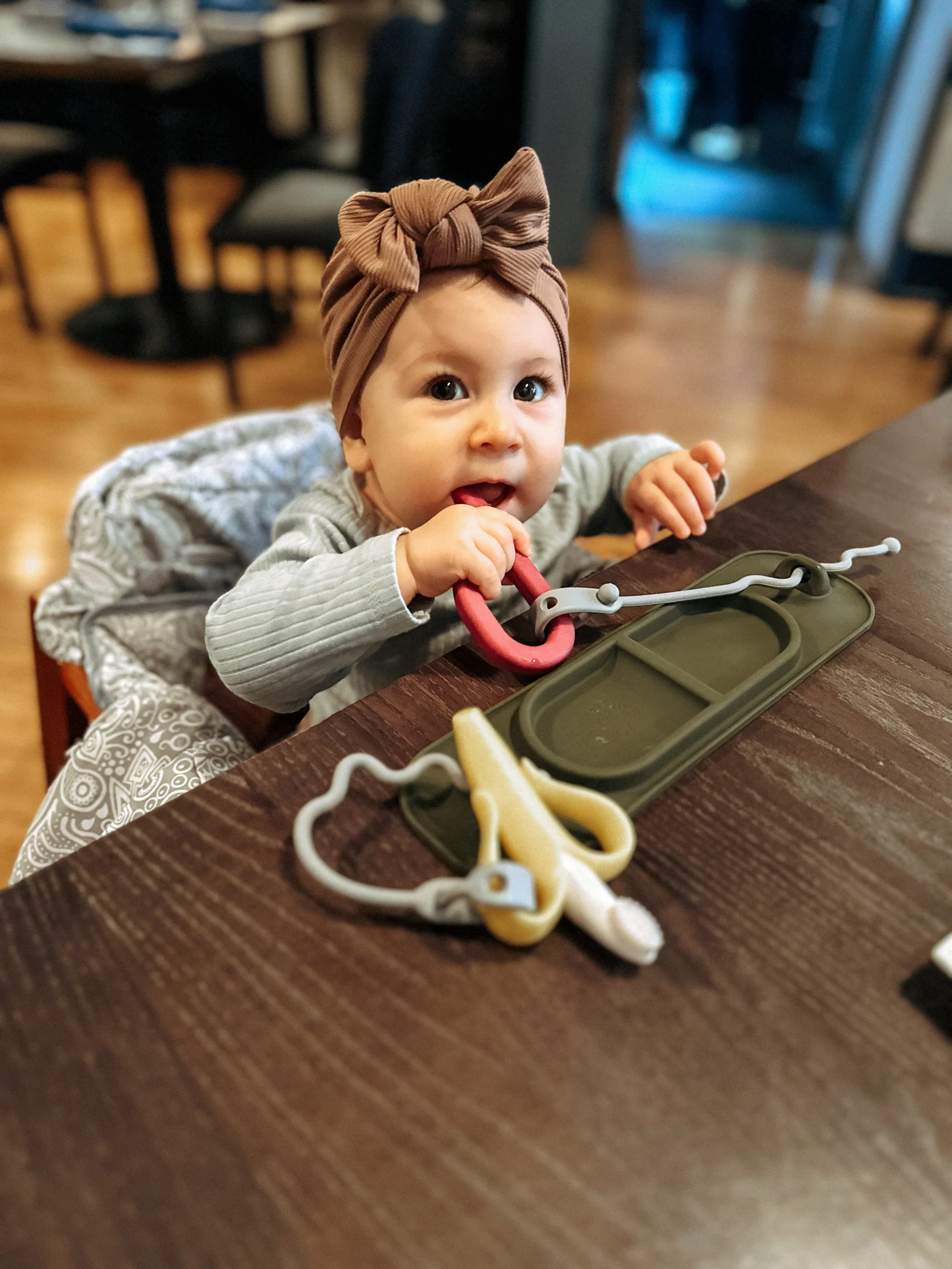  The   busy mat   is our FAVE! It’s really a genius design! Pop those teethers through the silicone strings and nothing falls to the ground!  We LOVE it!  