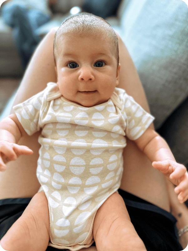 Newborn looks at the camera with bright eyes