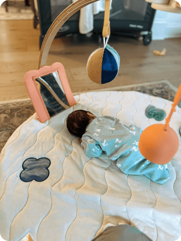 Newborn does tummy time on the new Lalo Play Gym II.