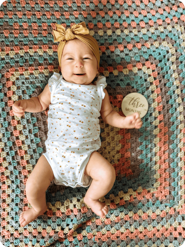 baby laying on blanket