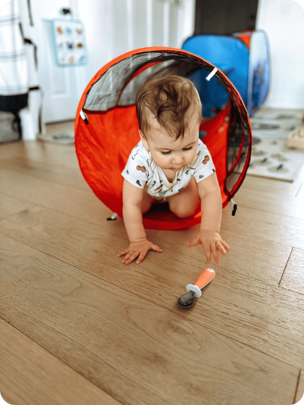 Baby crawls through a tunnel