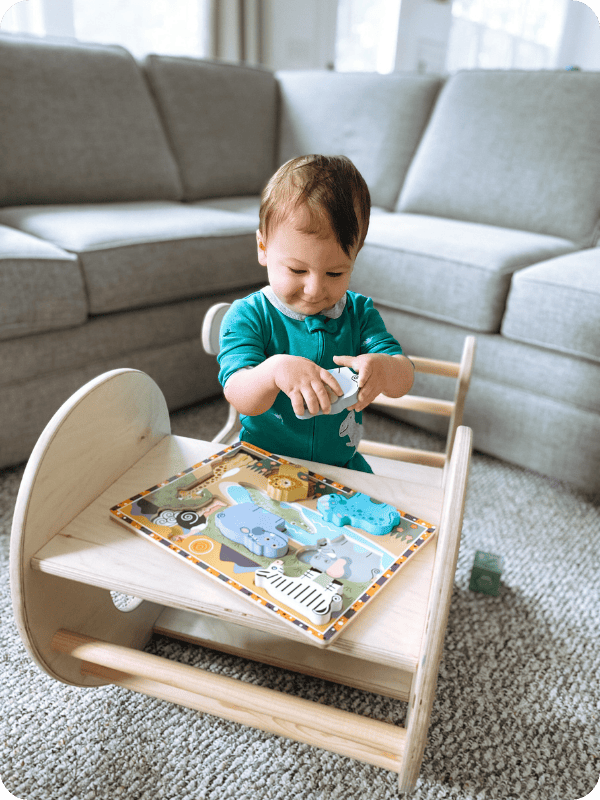 15 month old plays with a developmental puzzle toy.
