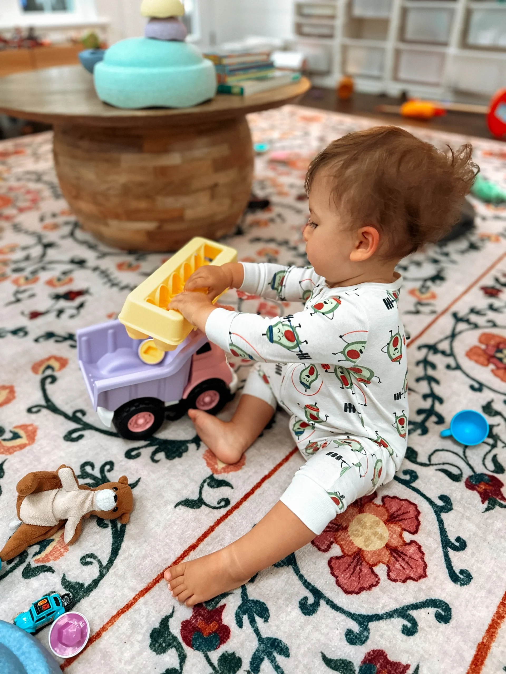  My toddler, Penelope, 15 months, playing with a dump truck and matching eggs. 