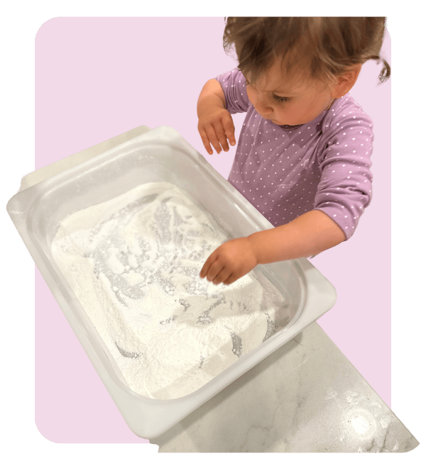 Toddler plays with a taste-safe sensory bin
