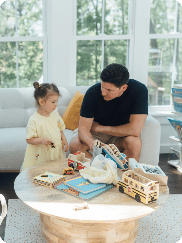 Dad and toddler play with toys together