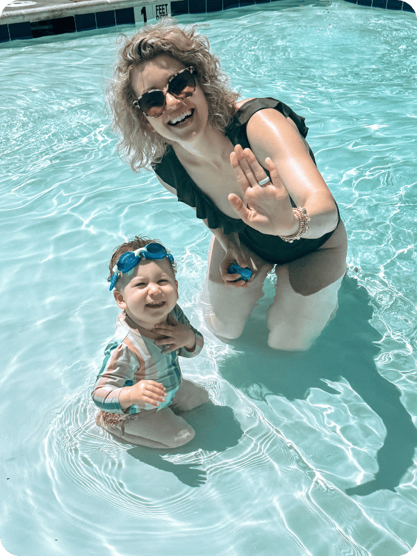 mom and toddler in the pool with swim goggles on