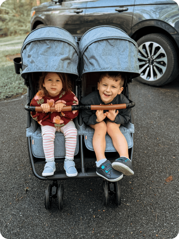 zoe travel stroller with two toddlers in tow