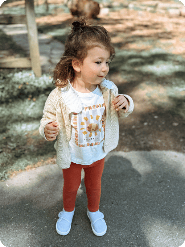 toddler girl wearing Stonz toddler sneakers outside