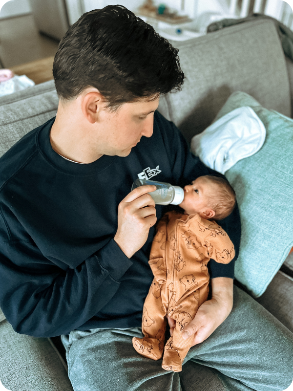 Dad feeds baby a bottle