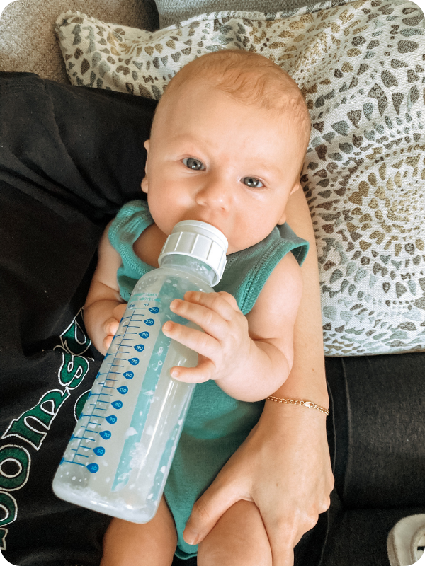 Baby holds his own bottle