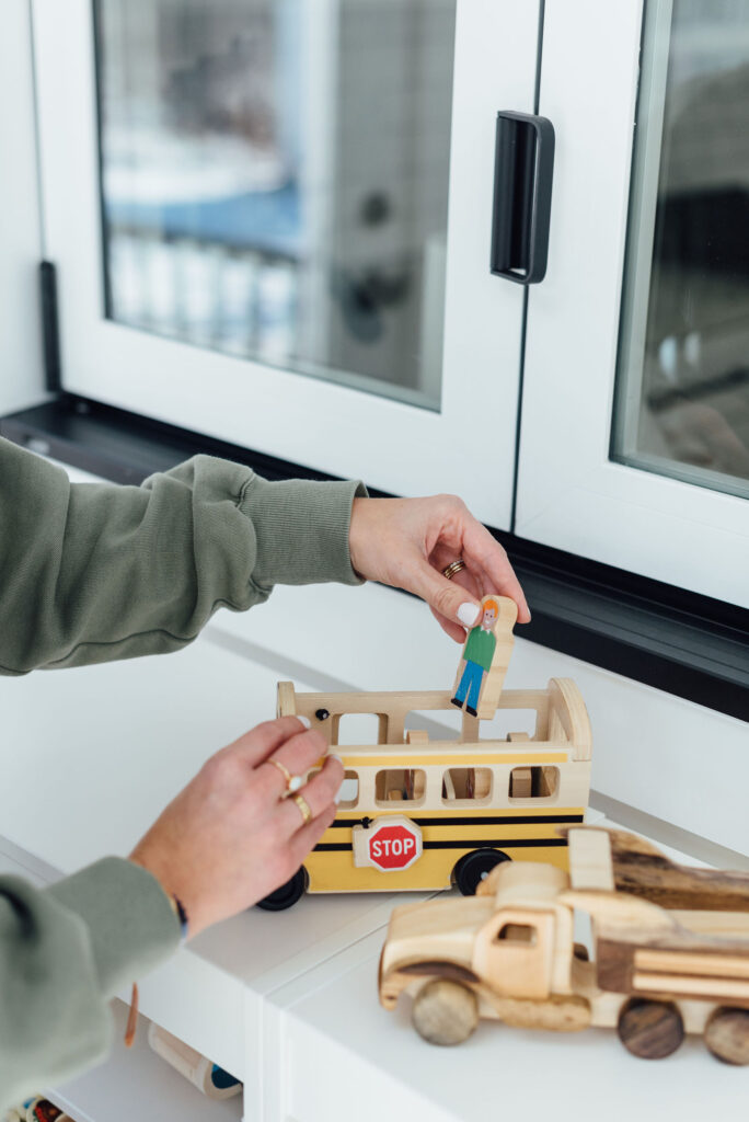 Melissa & Doug school bus on a toy shelf displaying how the play figures fit into the bus