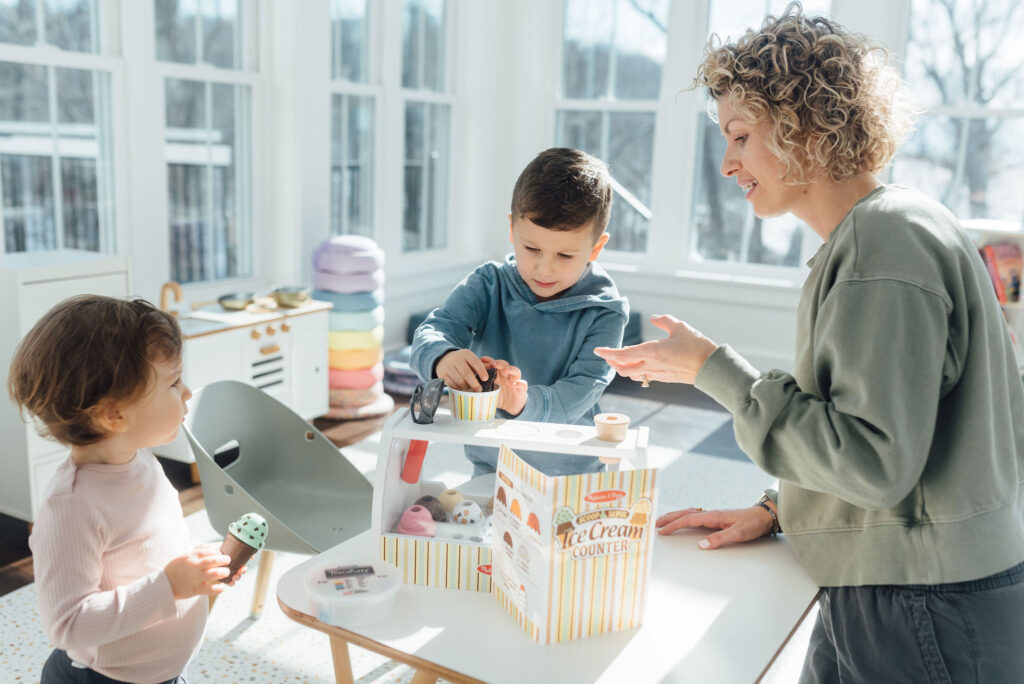 mother and two children playing with ice cream set, showing how the toy supports imaginative play at all ages