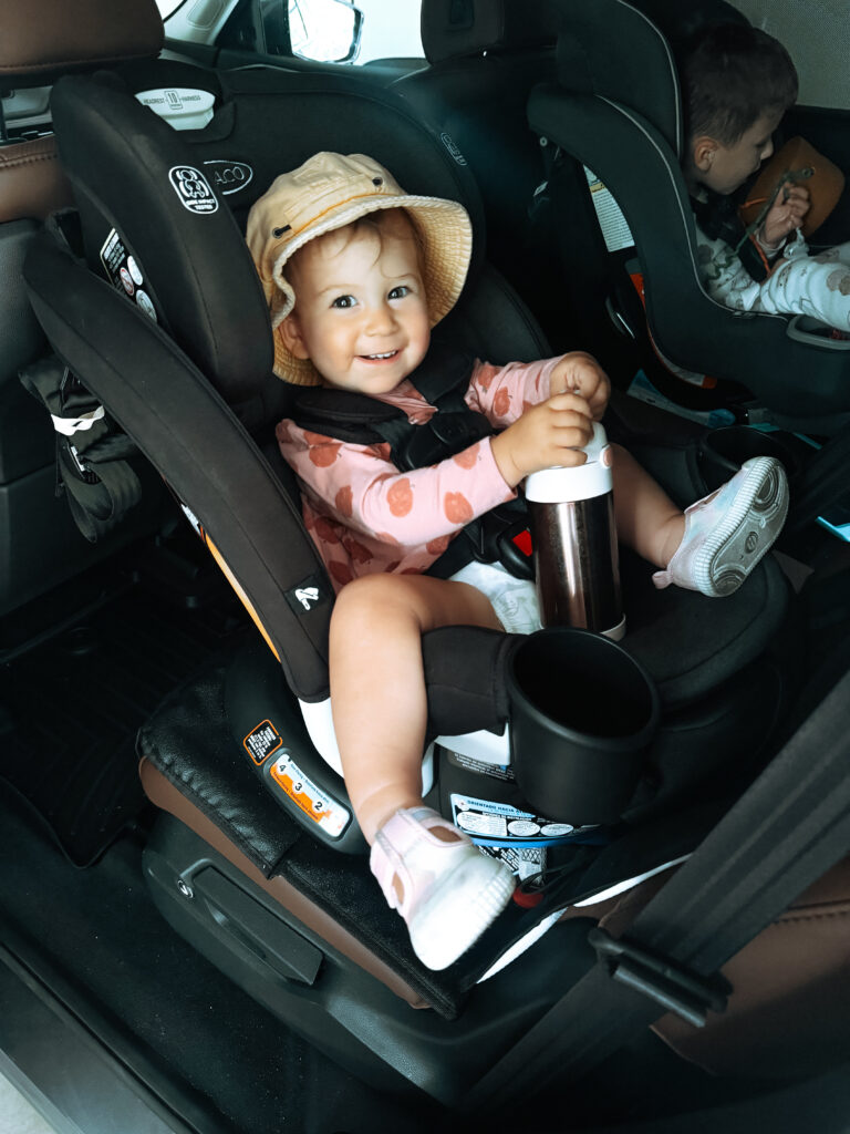 toddler girl in rear-facing Graco Turn2Me rotating car seat