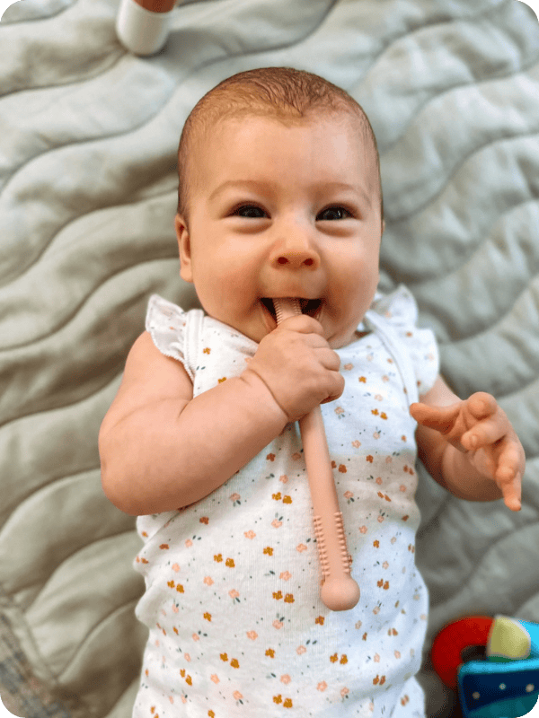 infant with baby teething toy
