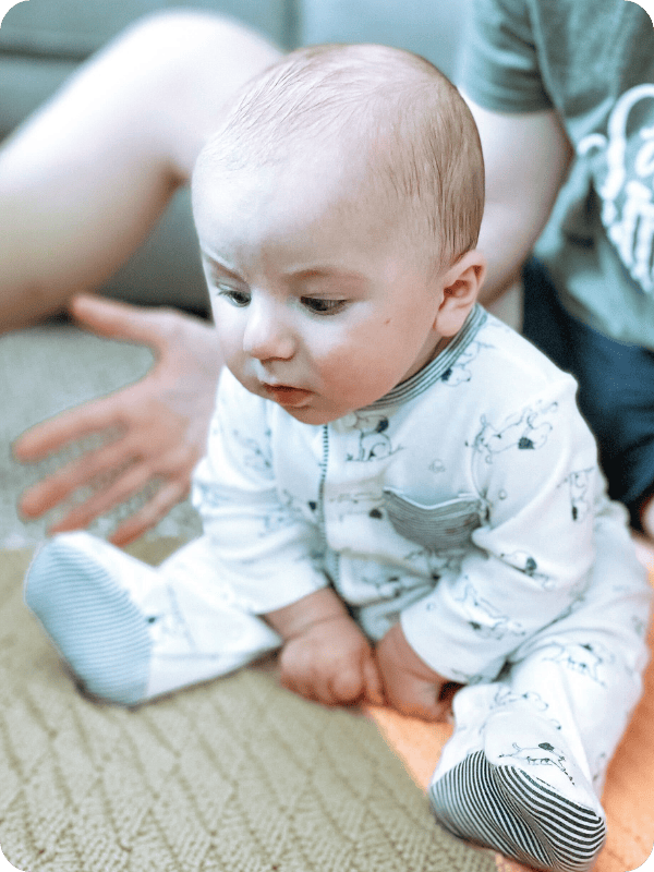 Infant learns to sit with the "prop sit" position.