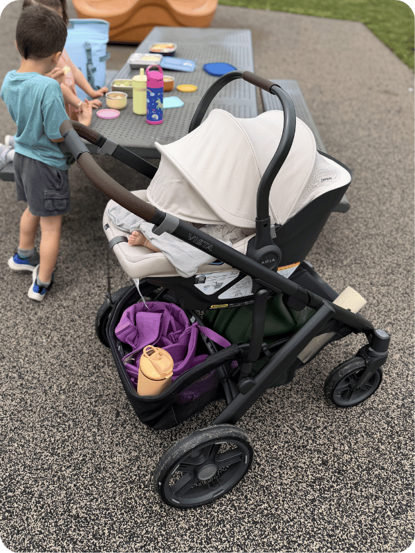 Uppababy Aria infant car seat on a Vista stroller, being used at the park