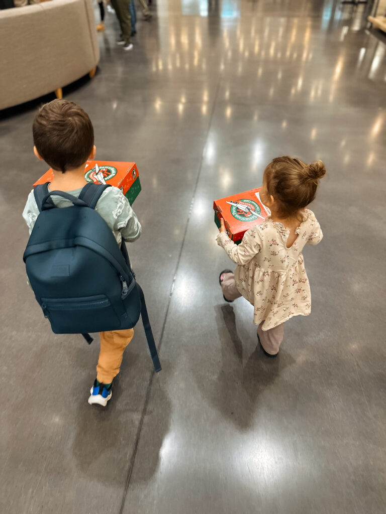 children donate toys to other children in need