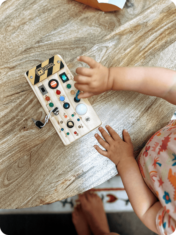 LED light busy board being played with by toddler