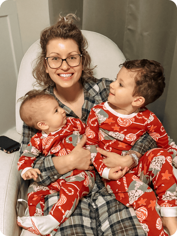 mom, bab, and toddler in Burt's Bees Baby holiday pajamas