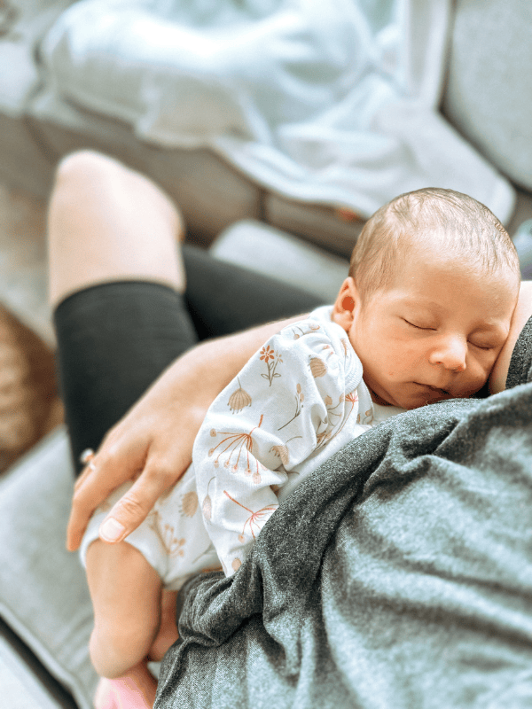 Newborn asleep on mother