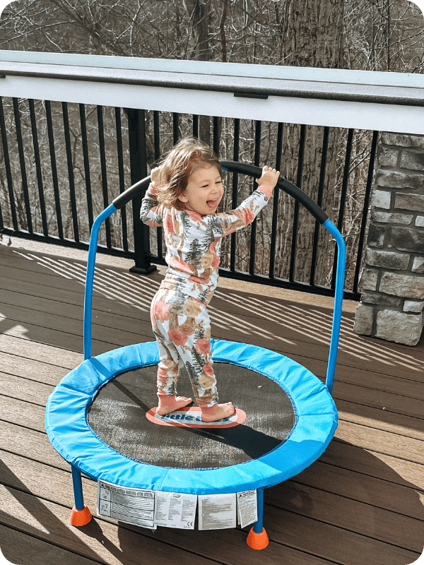 toddler girl jumping on a little tikes toddler trampoline