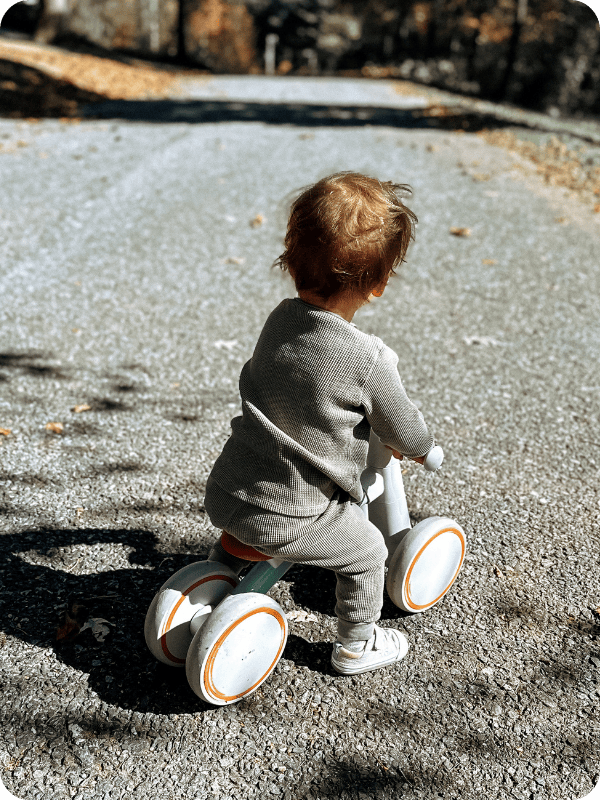 toddler riding on balance bike