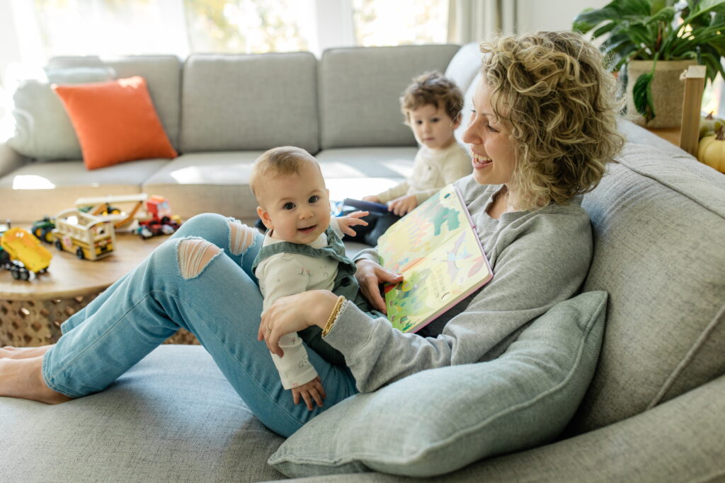 Mom reading to baby on the couch