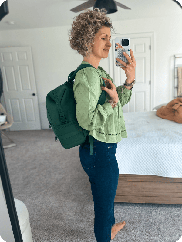 Mom wearing Dagen Dover diaper bag in pine green color