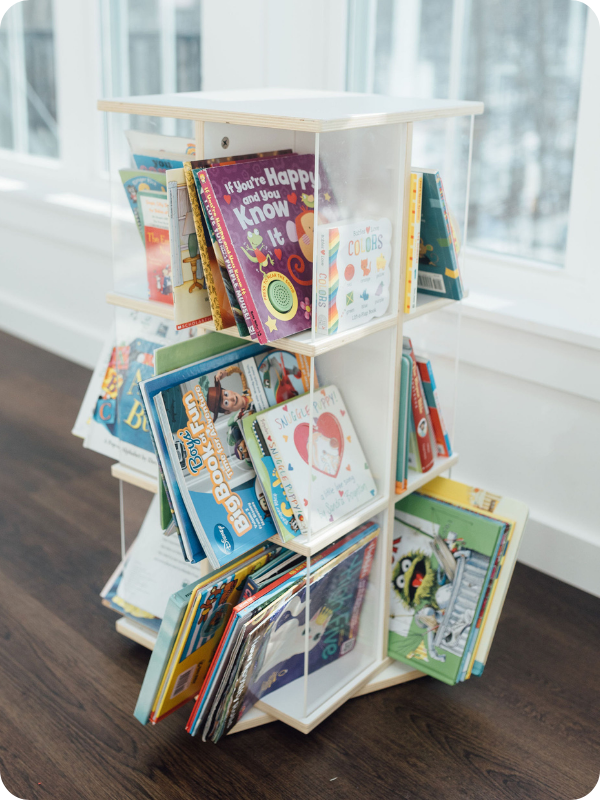Guidecraft rotating kids' bookshelf lined with children's books
