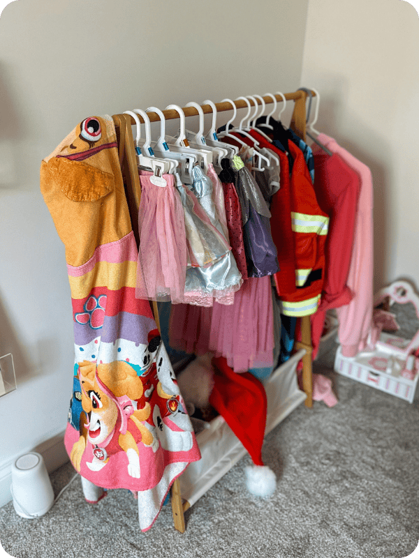 kids' dress up storage rack with costumes hanging