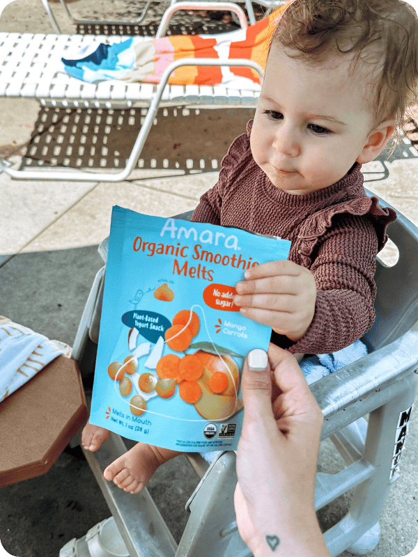 toddler eating amara smoothie melts