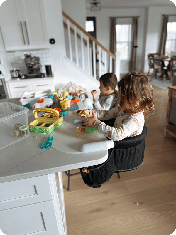 Toddlers play with Play Doh set.