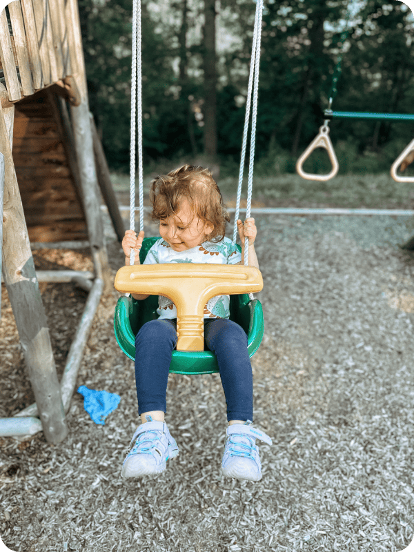 toddler swings on a playset