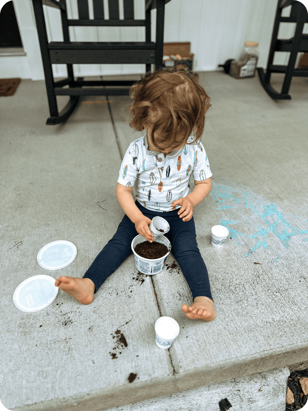 toddler does sensory activity outdoors