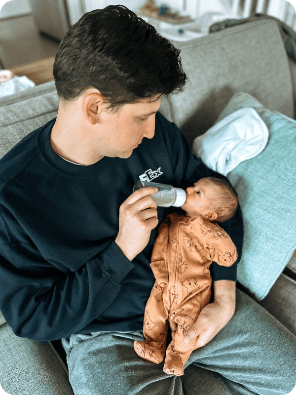 Dad feeding baby from Dr. Brown's bottle