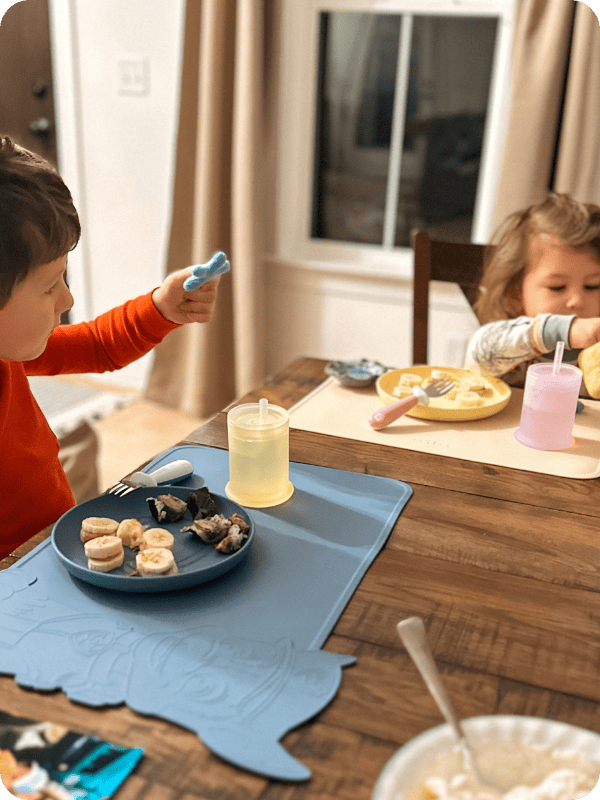 toddlers eating breakfast with Lalo silicone plates 