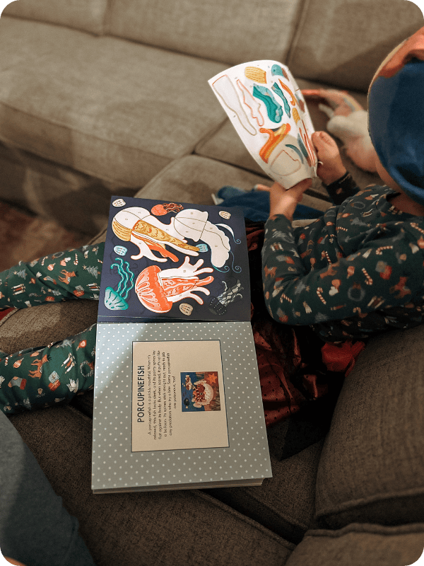 toddler working on paint by sticker book activity