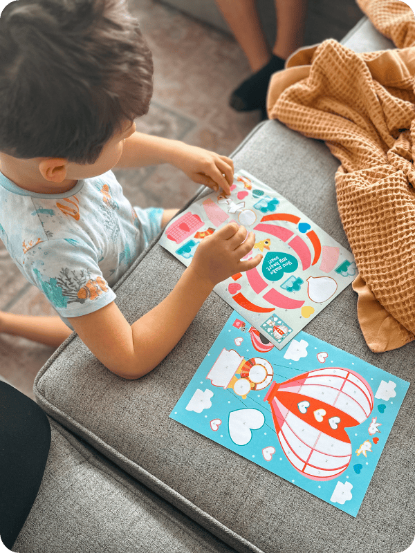 toddler working on sticker book