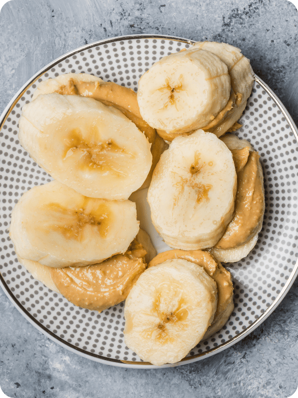 Banana and peanut butter "sandies" on a polka dotted plate