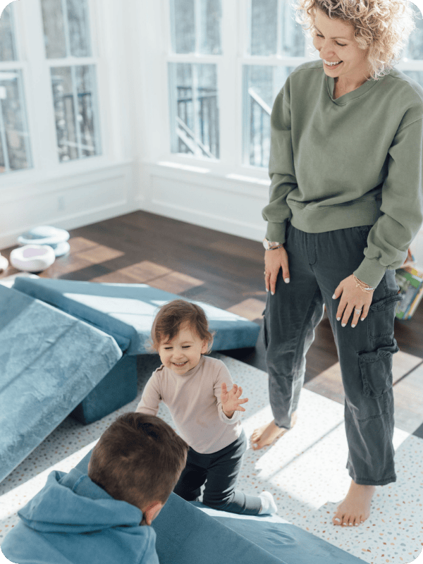 family playing on play couch together 