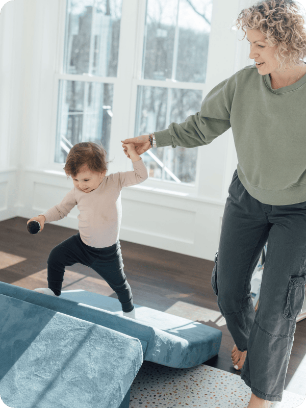 toddler climbing on a play couch
