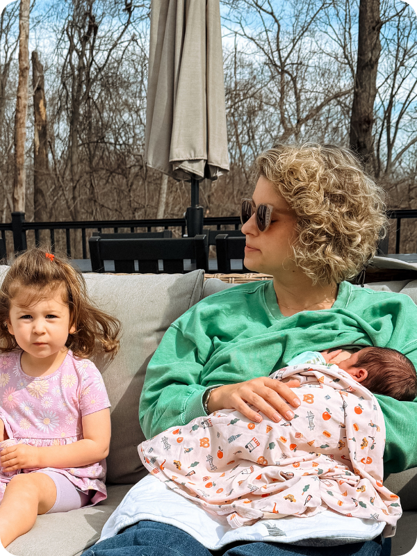 mom nursing baby outside