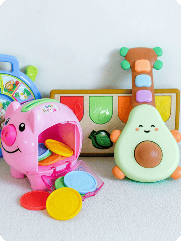 Infant toys, including a light up avocado guitar for infants.