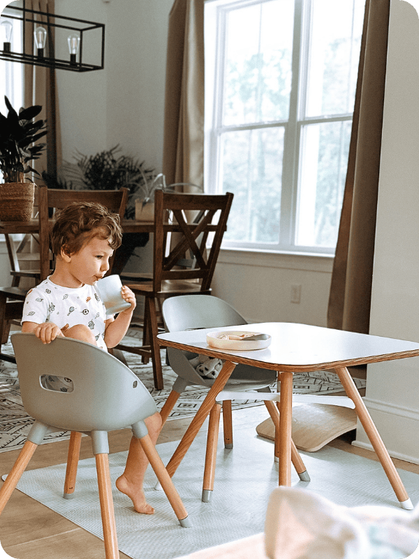 young toddler eating on lalo table and chairs