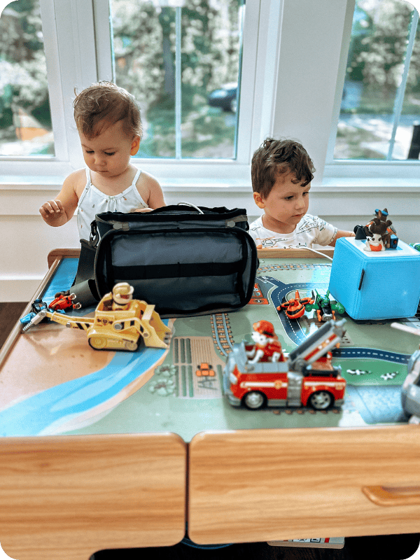toddlers playing at train table