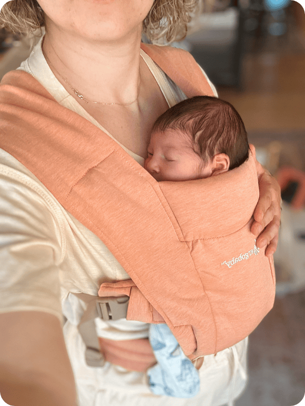mom carrying newborn in ergo embrace carrier