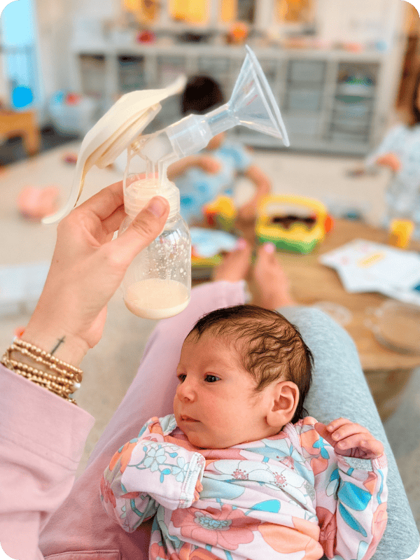 mom using medela hand pump 