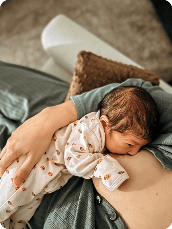 woman nursing in long sleeve pajamas
