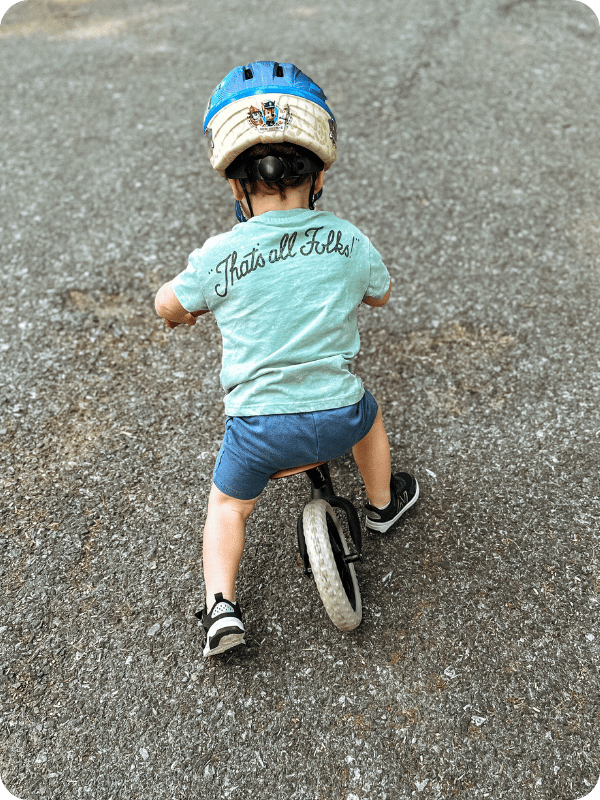 toddler riding balance bike